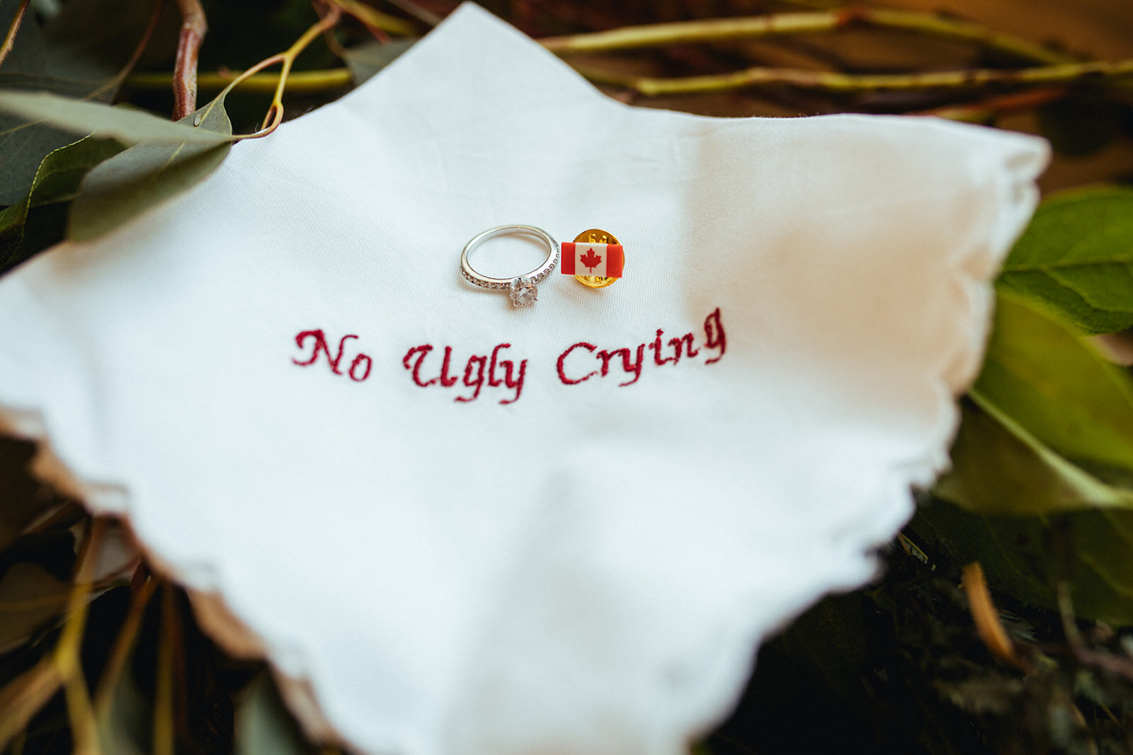 Wedding band and pin on a handkerchief in DC Shawnee Custalow photography