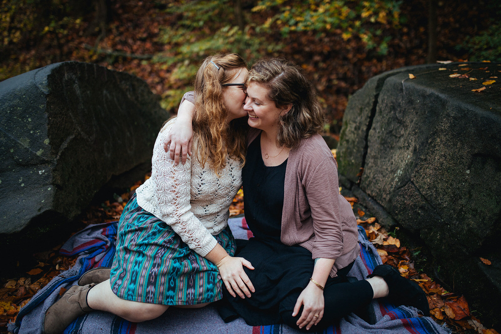 Engaged LGBTQ couple embracing on a blanket in Forest Hill Park RVA Shawnee Custalow