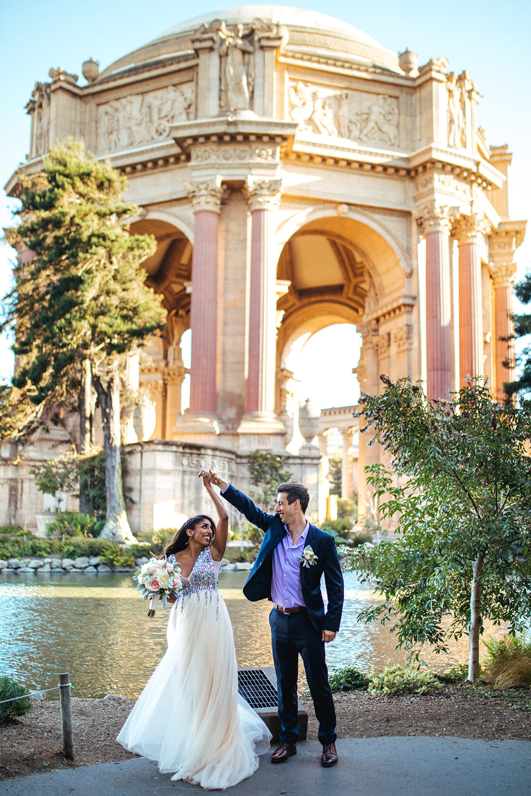 Groom twirling the bride at the Palace of Fine Arts CA Shawnee Custalow Photography
