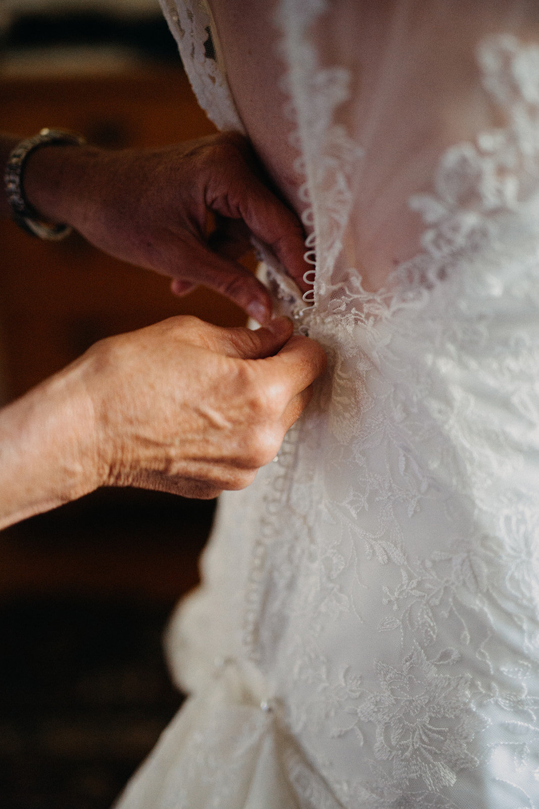Buttoning wedding dress in Cape Cod Shawnee Custalow photography