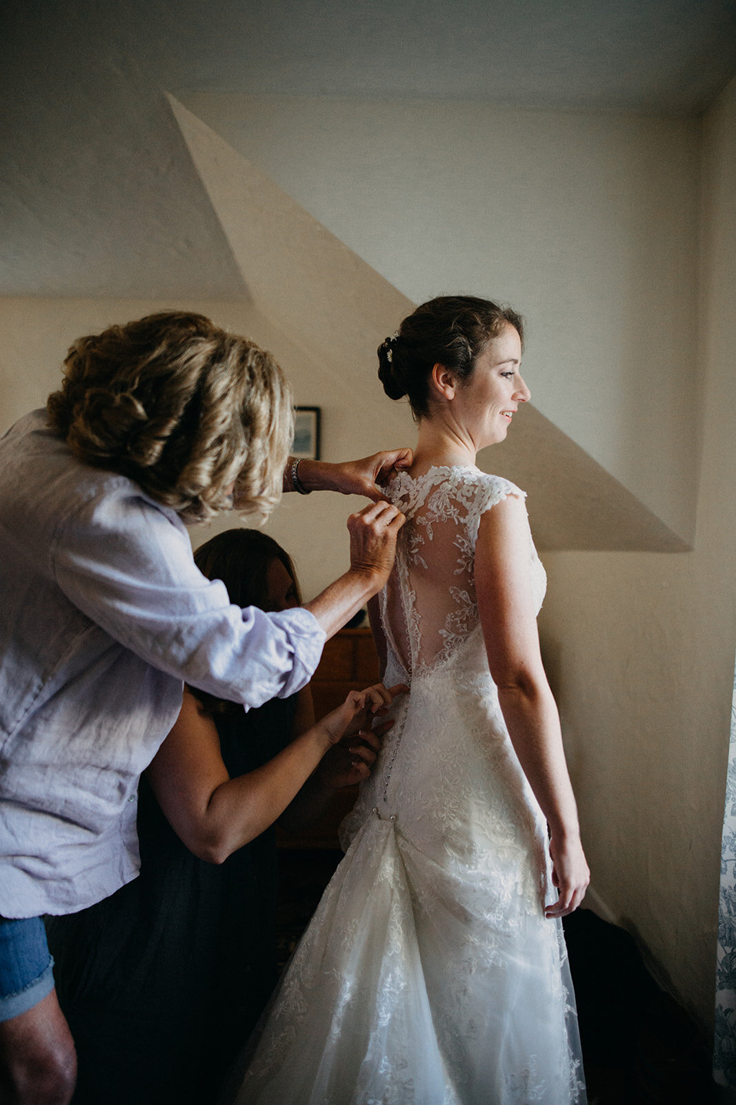 Bride putting on dress in Cape Cod MA Shawnee Custalow photography