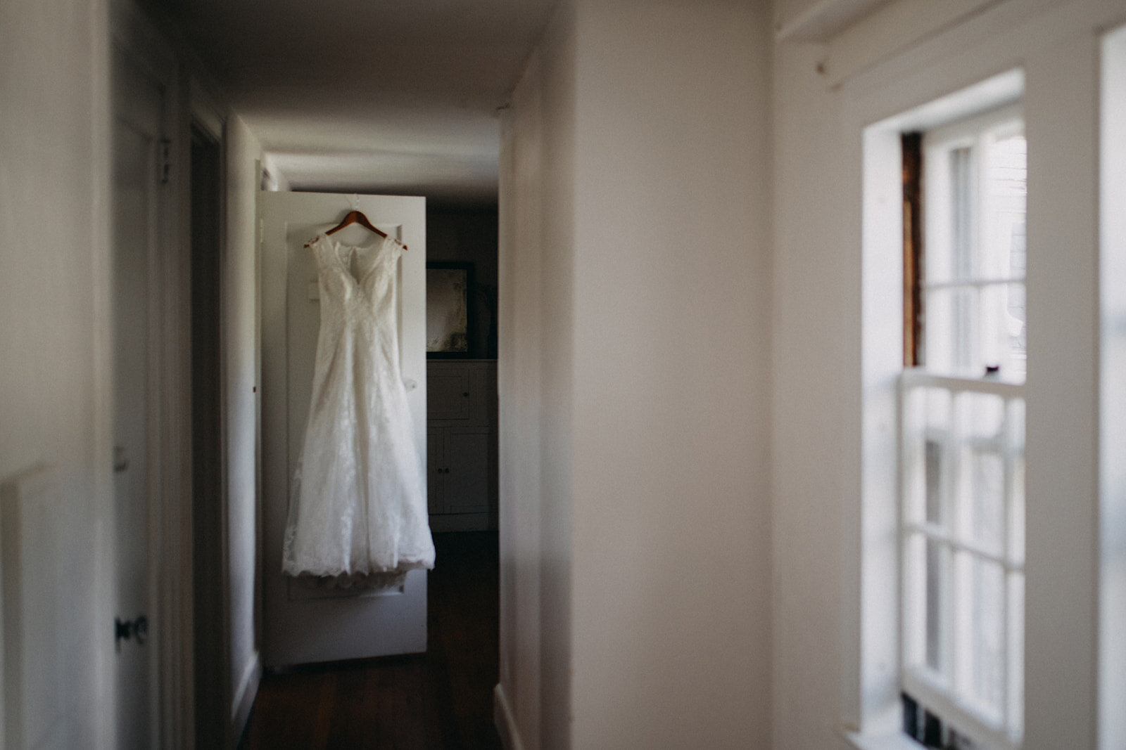 Wedding dress hanging in Cape Cod Shawnee Custalow photography