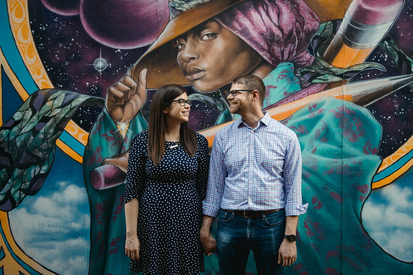Engaged couple by an art mural in DC Shawnee Custalow photography