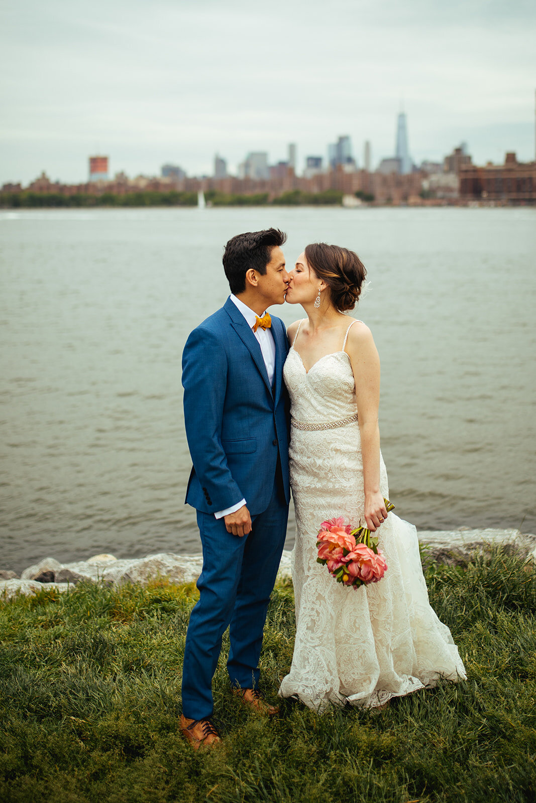 Future spouses kissing in Brooklyn by NYC skyline Shawnee Custalow wedding photography