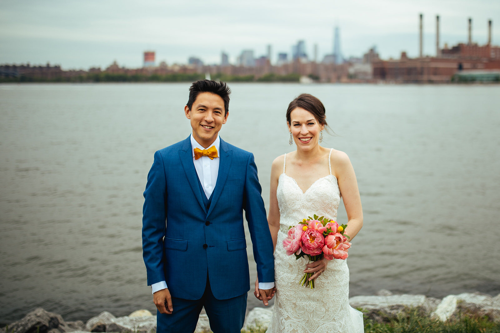 Bride and groom holding hands by the Hudson River NYC Shawnee Custalow wedding photography