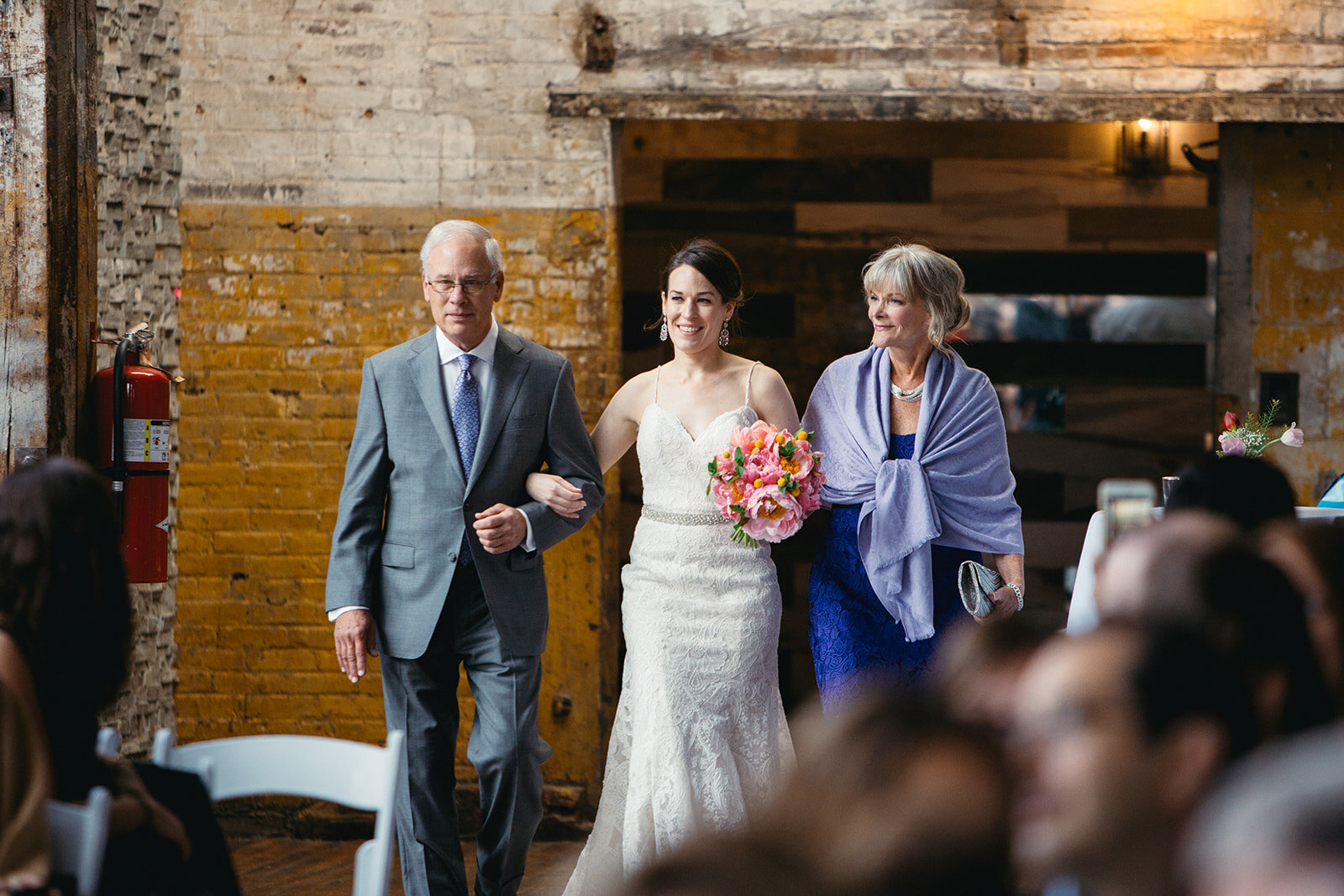 Bride escorted by parents at The Greenpoint Loft Brooklyn NY Shawnee Custalow wedding photo