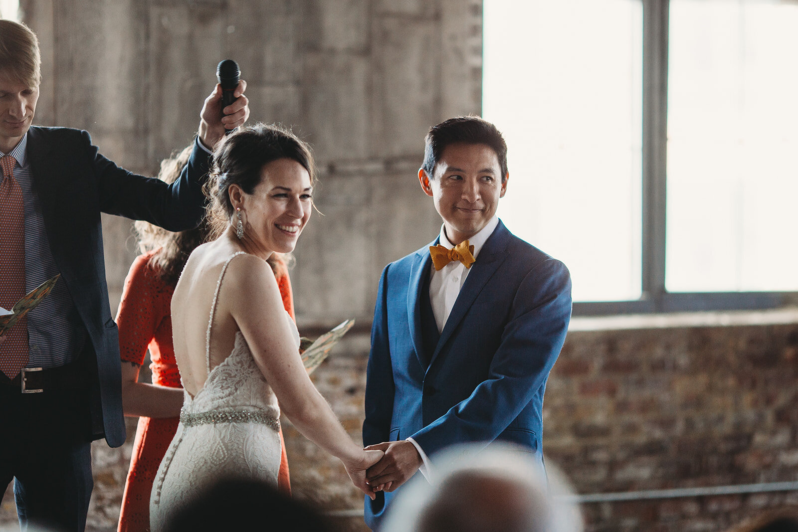 Bride and groom smiling at guests at The Greenpoint Loft Brooklyn NY Shawnee Custalow photography