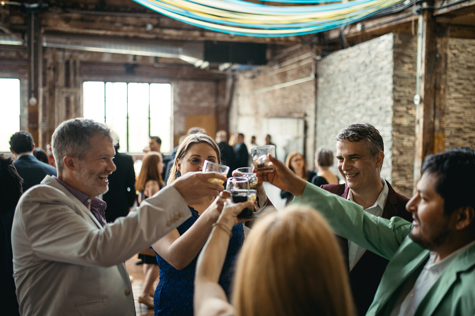 Guests raising a toast at the Greenpoint Loft wedding Brooklyn NYC Shawnee Custalow