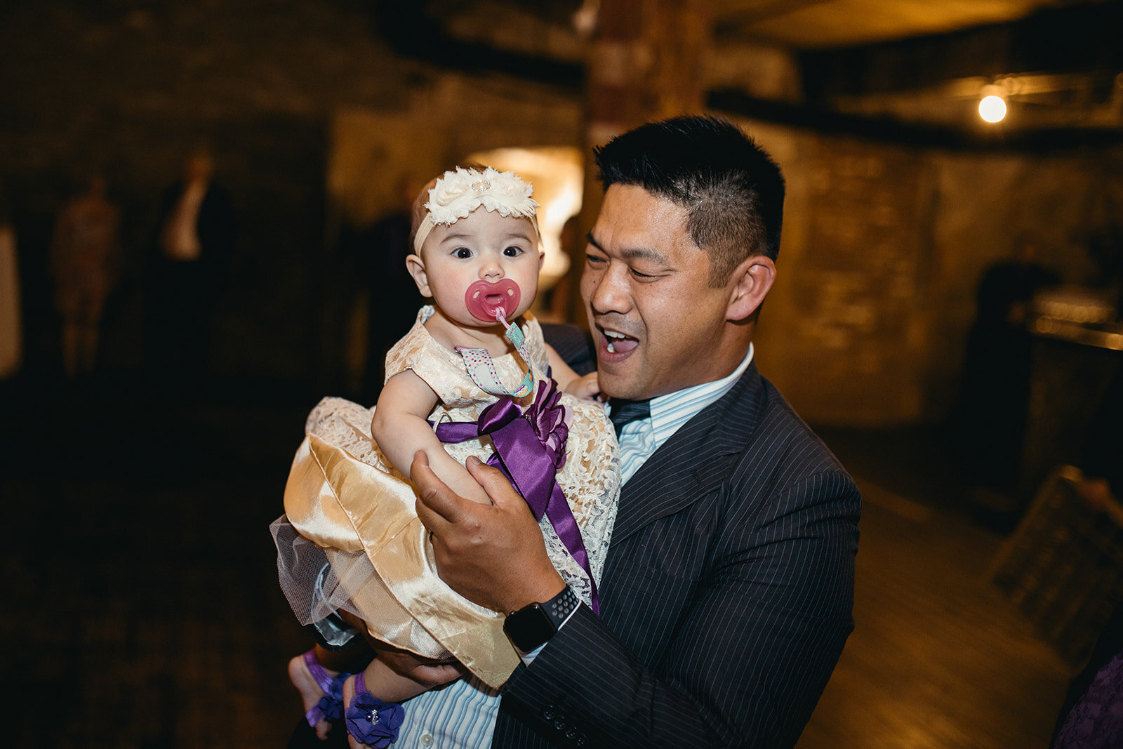 Wedding guest holding infant at the Greenpoint Loft Brooklyn Shawnee Custalow photography