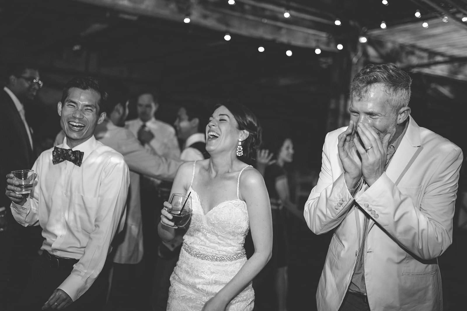 Newlywed and guests laughing at the Greenpoint Loft Brooklyn NYC Shawnee Custalow photography