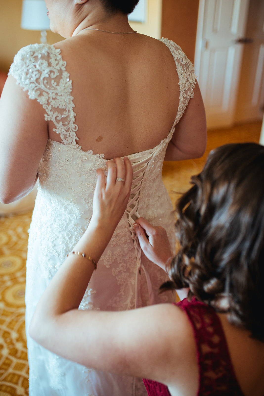 Future spouse putting on a wedding dress near DC Shawnee Custalow photography