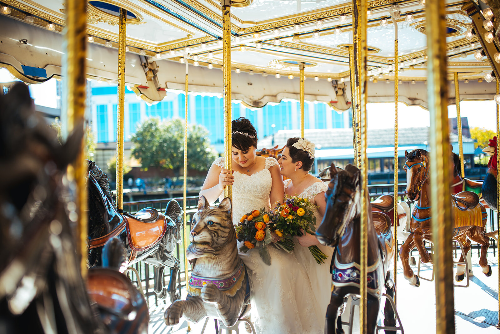 LGBTQ spouses on a carousel in Gaithersburg MD Shawnee Custalow wedding photography