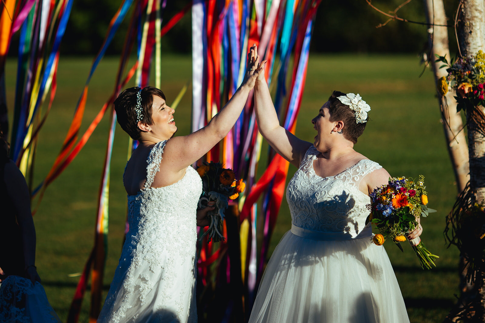 Queer newlyweds high fiving outside DC Shawnee Custalow wedding photography