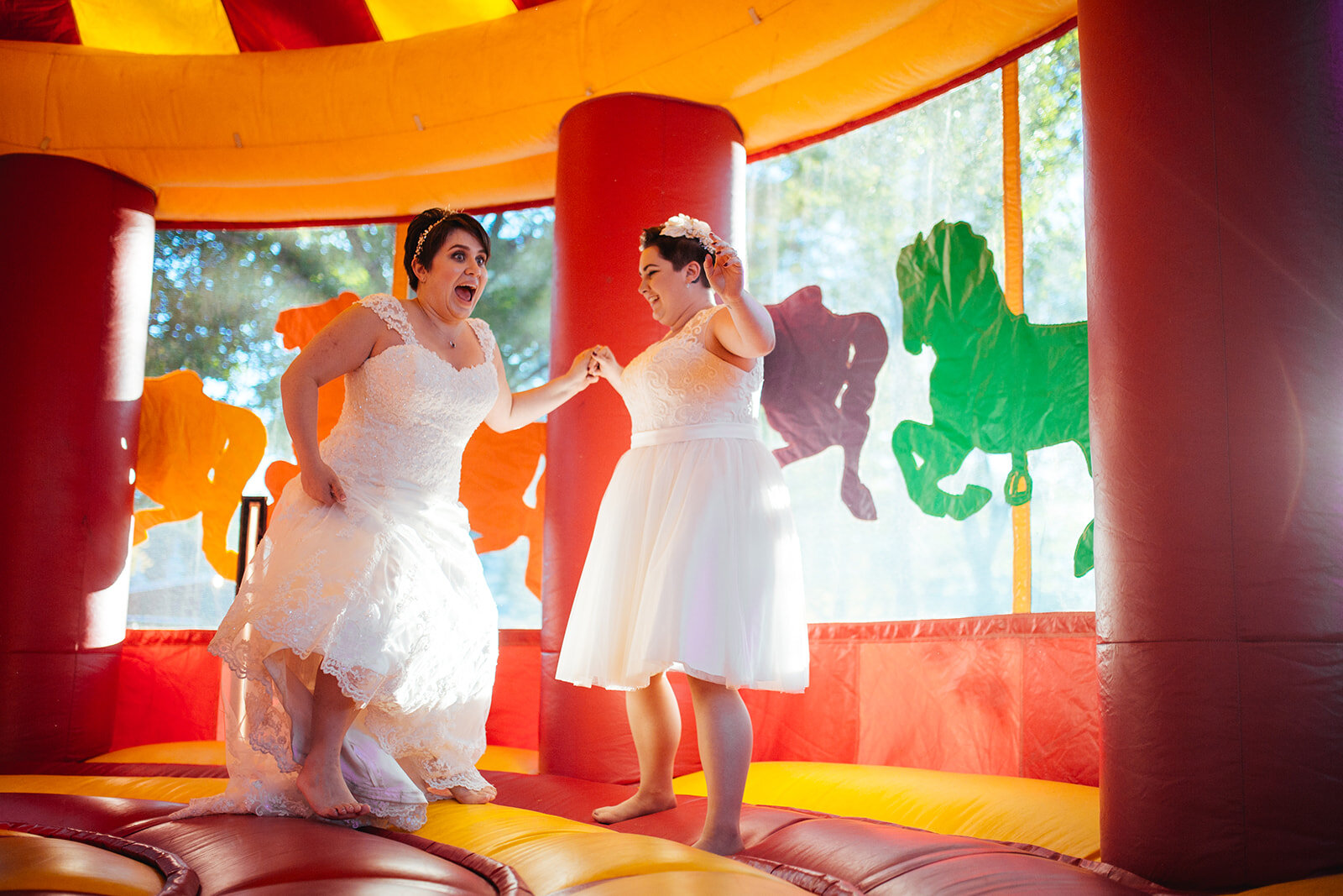 Newlyweds in a bounce house near DC Shawnee Custalow queer wedding photographer