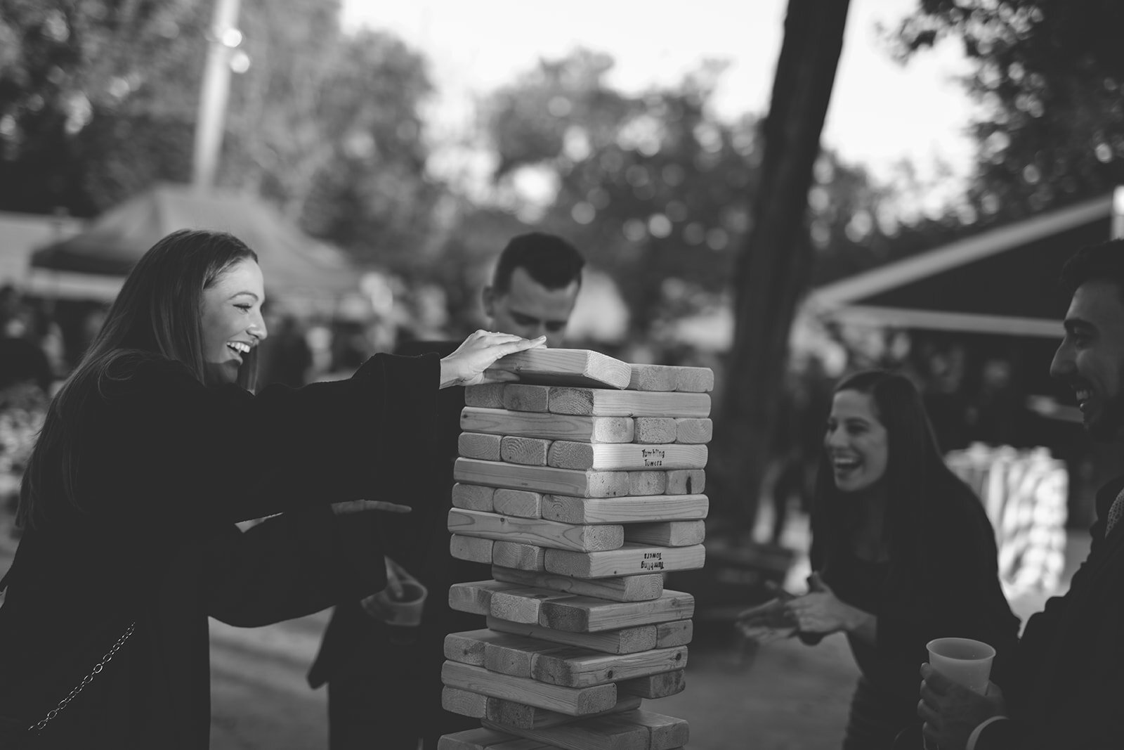 Guests playing giant Jenga outside DC Shawnee Custalow queer wedding photography