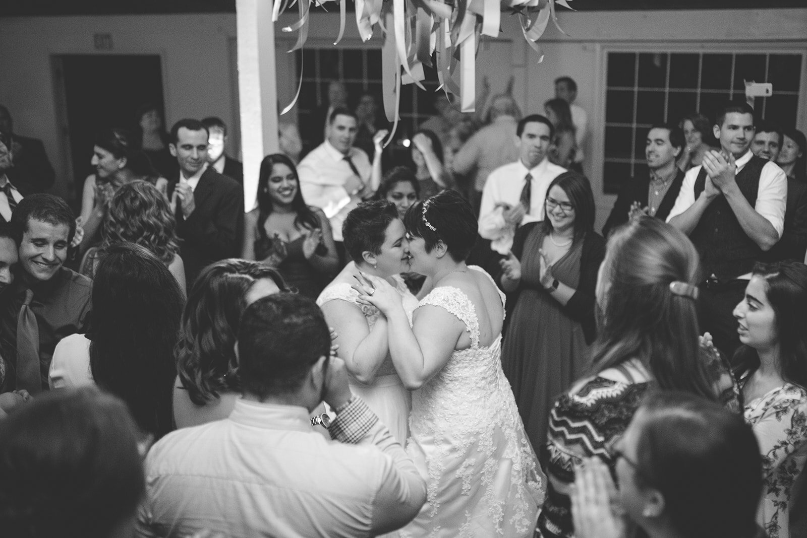 Newlyweds kiss at wedding reception in Gaithersburg MD Shawnee Custalow photography