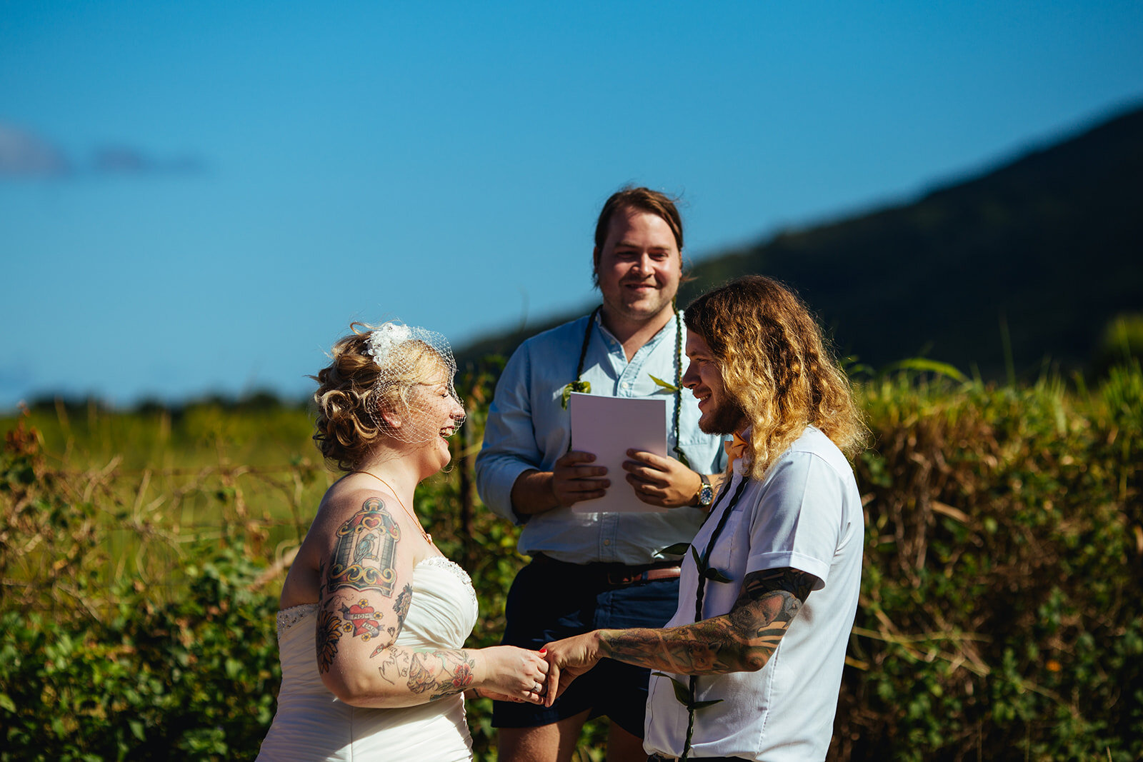 Bride and groom with the officiant in Kauai Hawaii Shawnee Custalow photography
