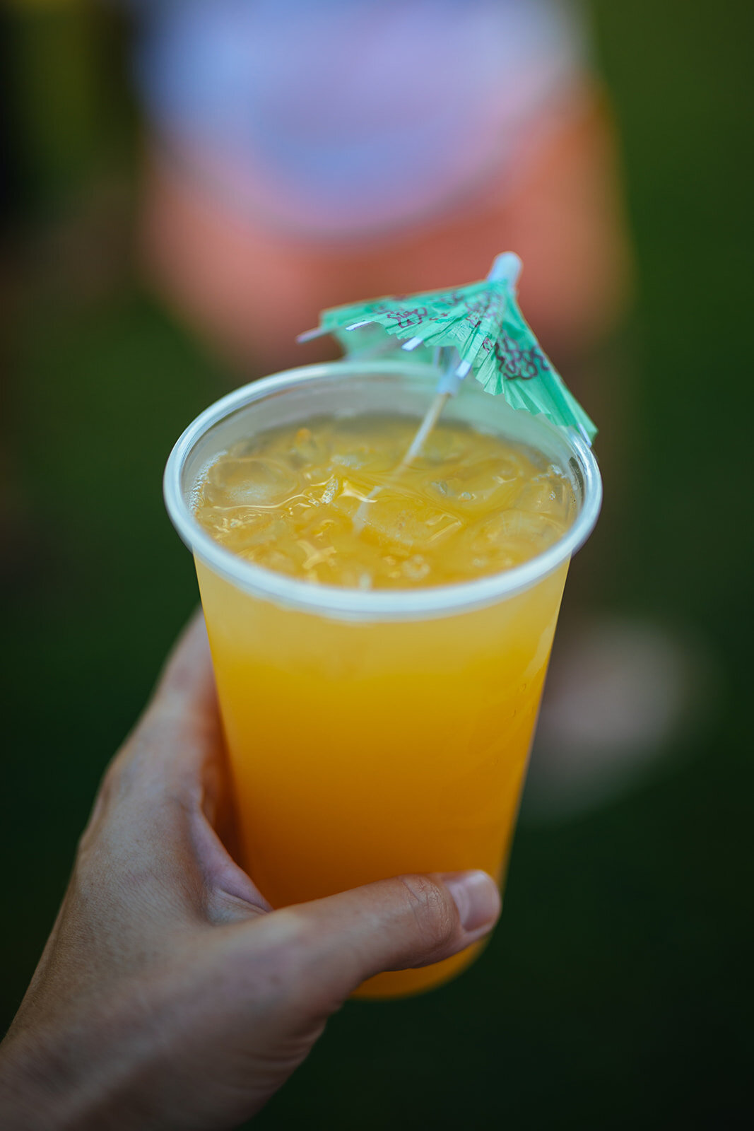 Orange drink with a tiny umbrella in Kauai HI Shawnee Custalow wedding photography