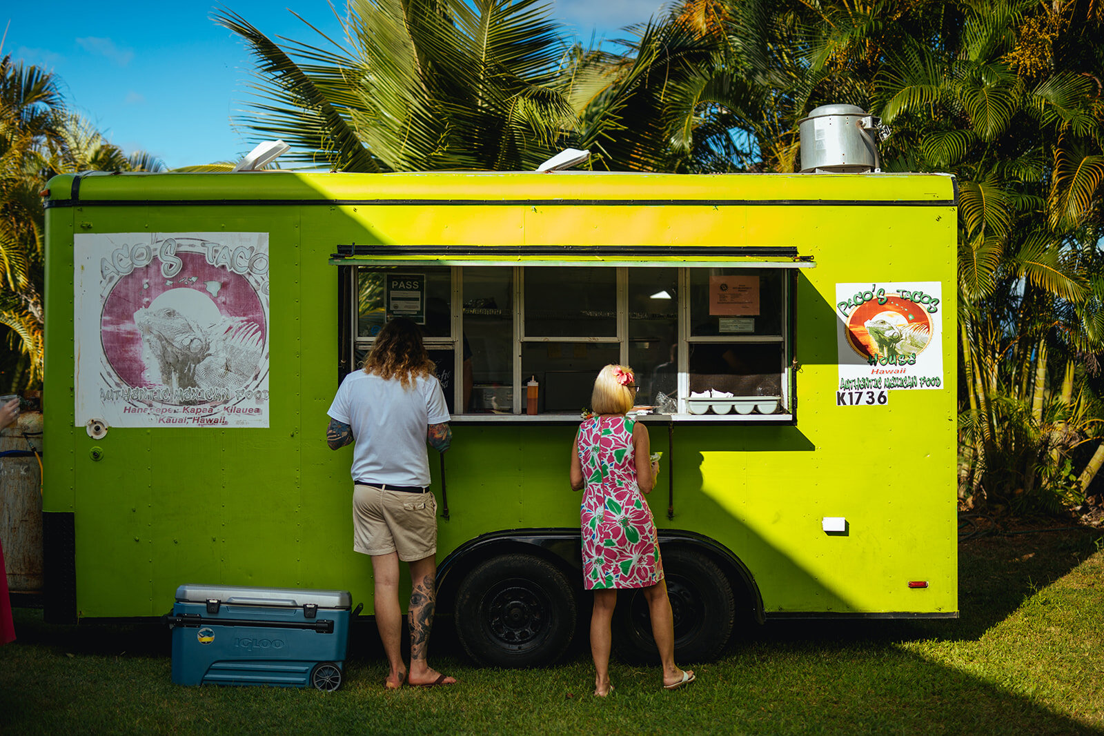 Newlywed and guest ordering from a food truck in Kauai HI Shawnee Custalow photography
