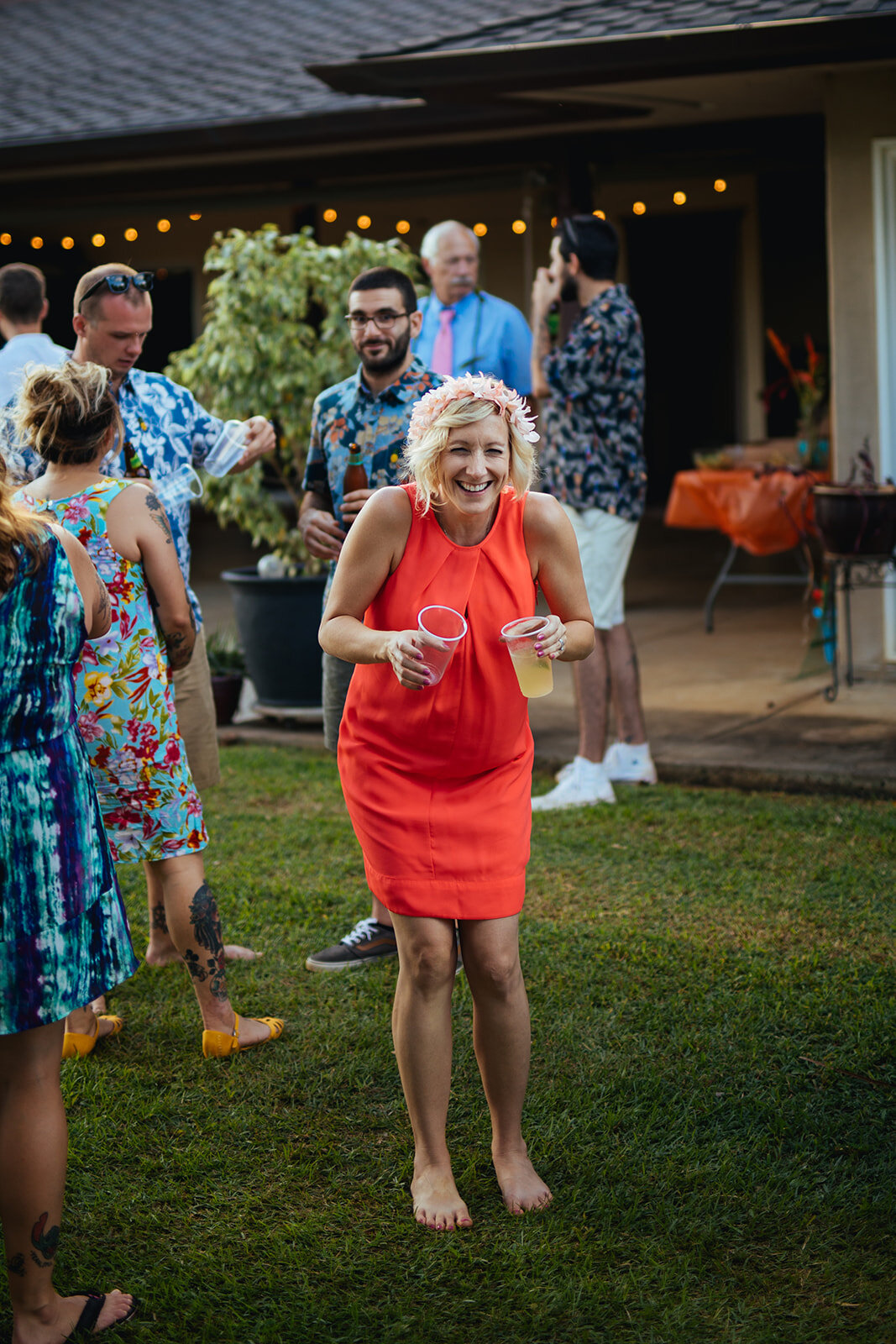 Wedding guest smiling with drinks in Kauai Hawaii Shawnee Custalow photography