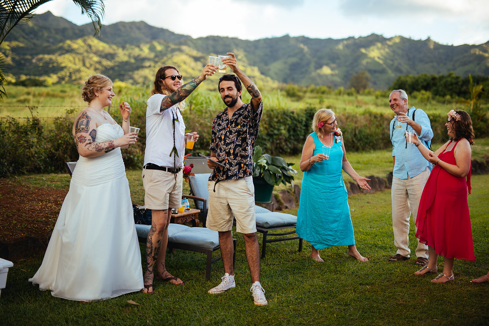 Newlyweds with guests toasting in Kauai Hawaii Shawnee Custalow wedding photography