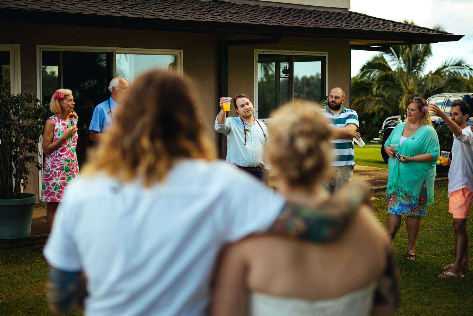 Guest raising a toast to the newlyweds in Kauai Hawaii Shawnee Custalow photography