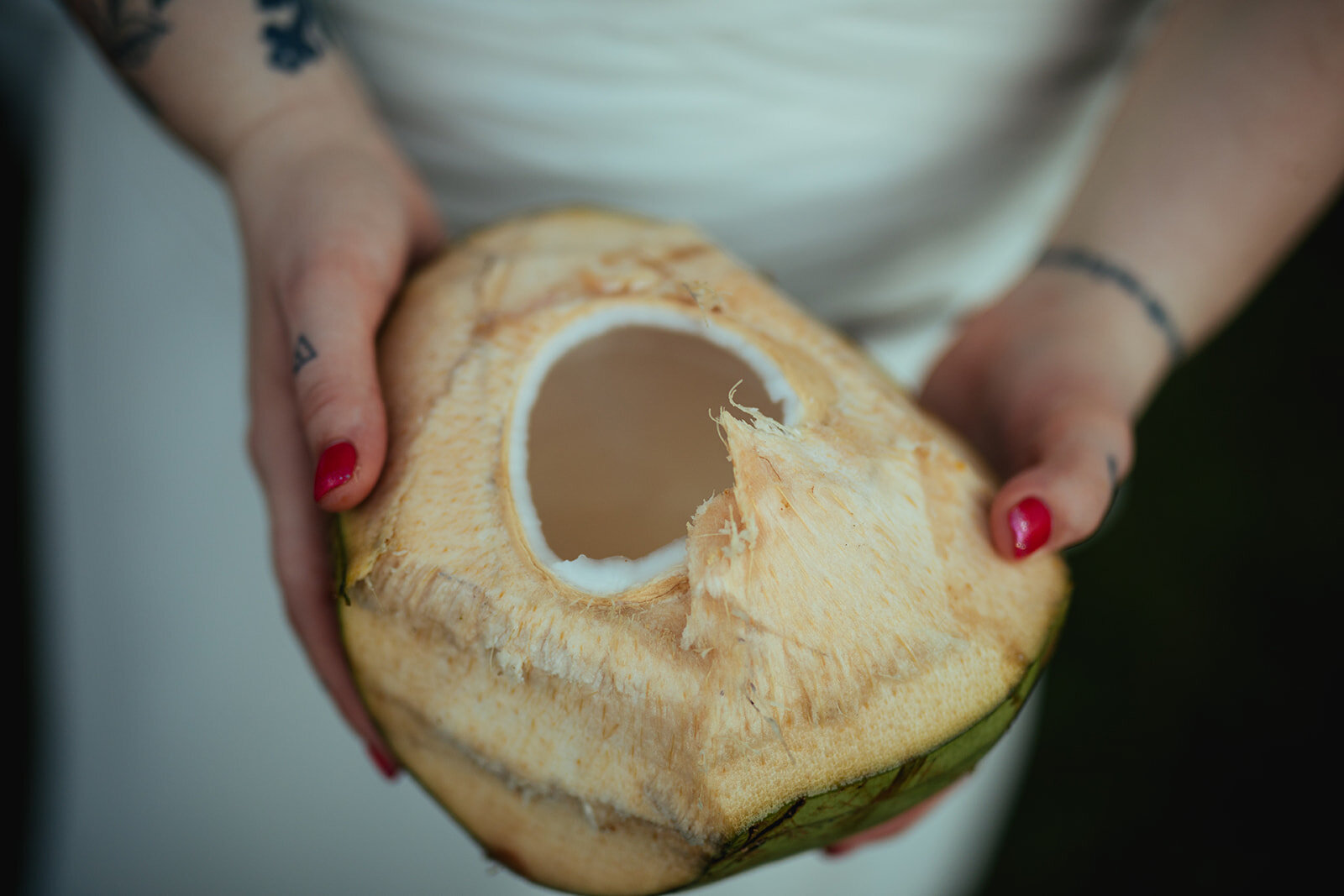 Bride holding a coconut in Kauai Hawaii Shawnee Custalow wedding photography