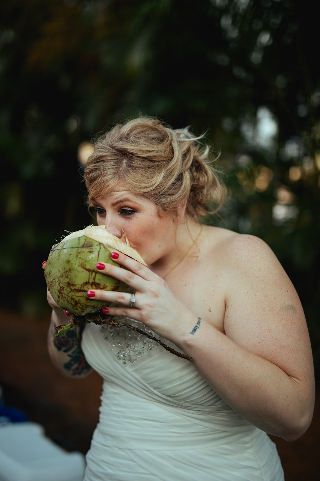 Bride drinking from a coconut in Kauai Hawaii Shawnee Custalow wedding photography