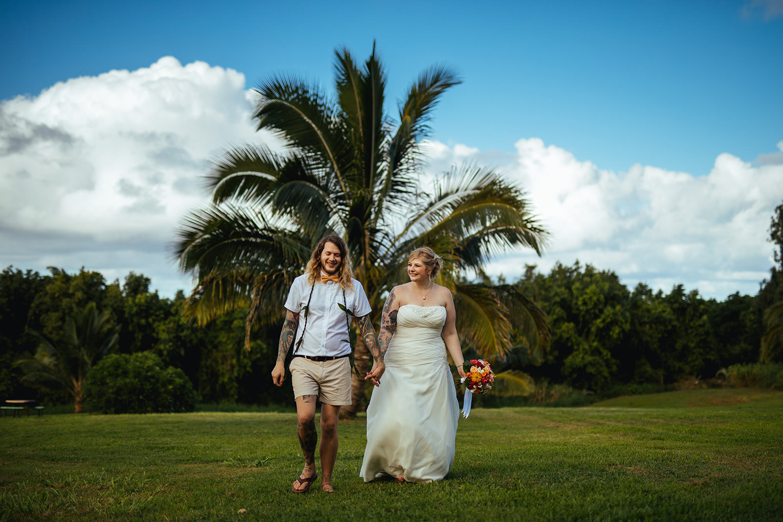 Newlyweds walking hand in hand in Kauai Hawaii Shawnee Custalow wedding photography