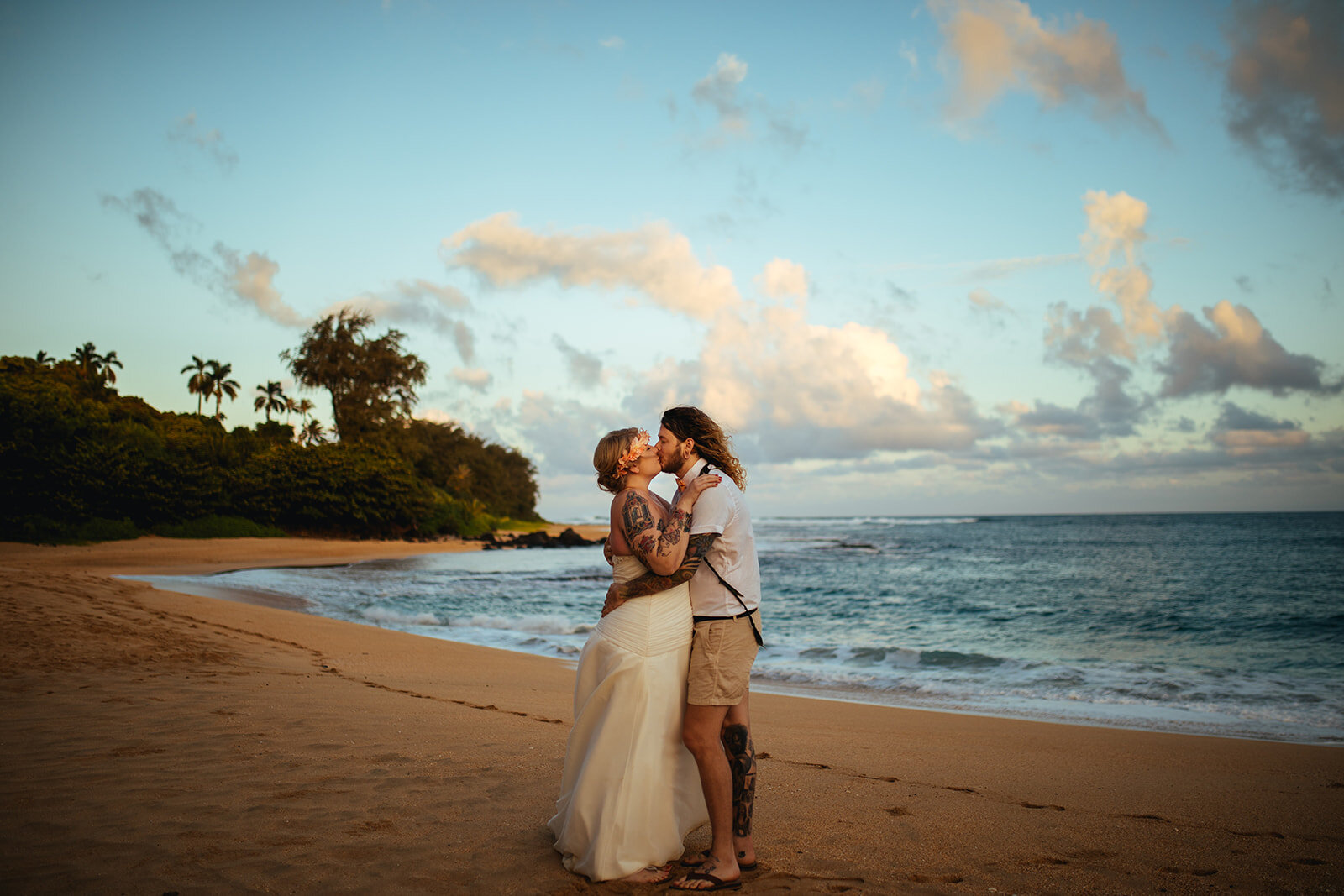 Newlyweds kissing on the beach in Kauai Hawaii Shawnee Custalow wedding photography