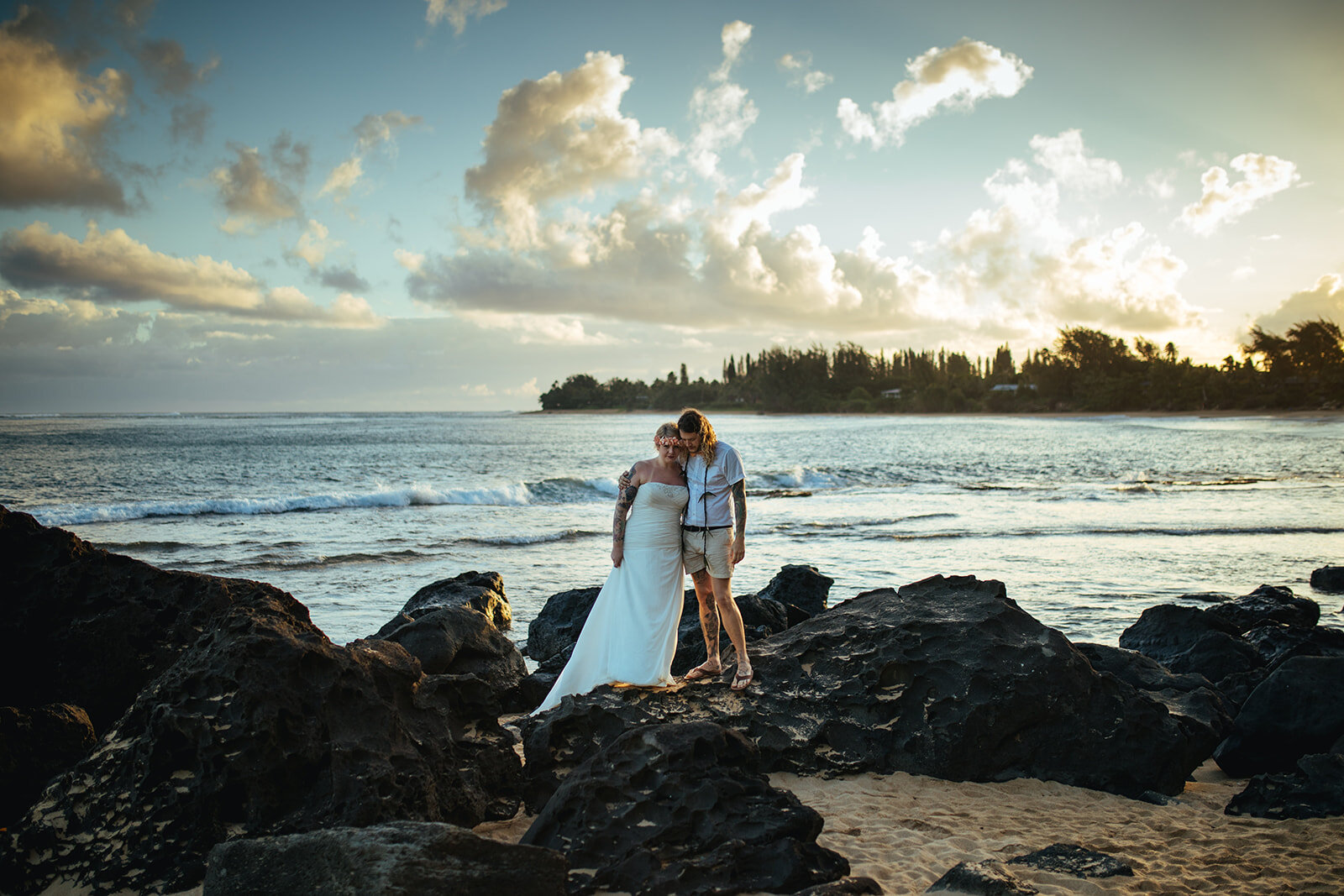 Newlyweds on rocks by the sea in Kauai Hawaii Shawnee Custalow wedding photography