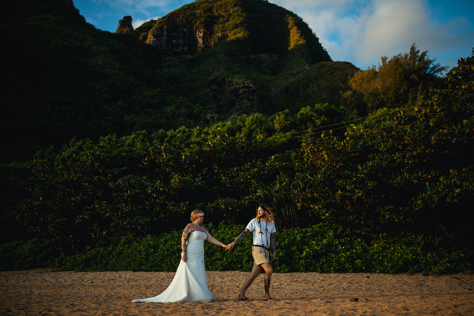 Newlyweds walking along the beach in Kauai Hawaii Shawnee Custalow wedding photography