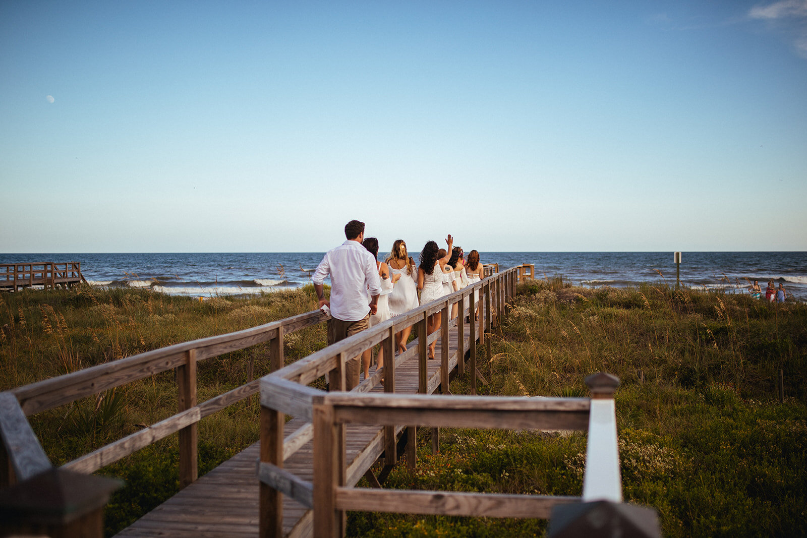 Wedding guests walking to Folly Beach Shawnee Custalow photography