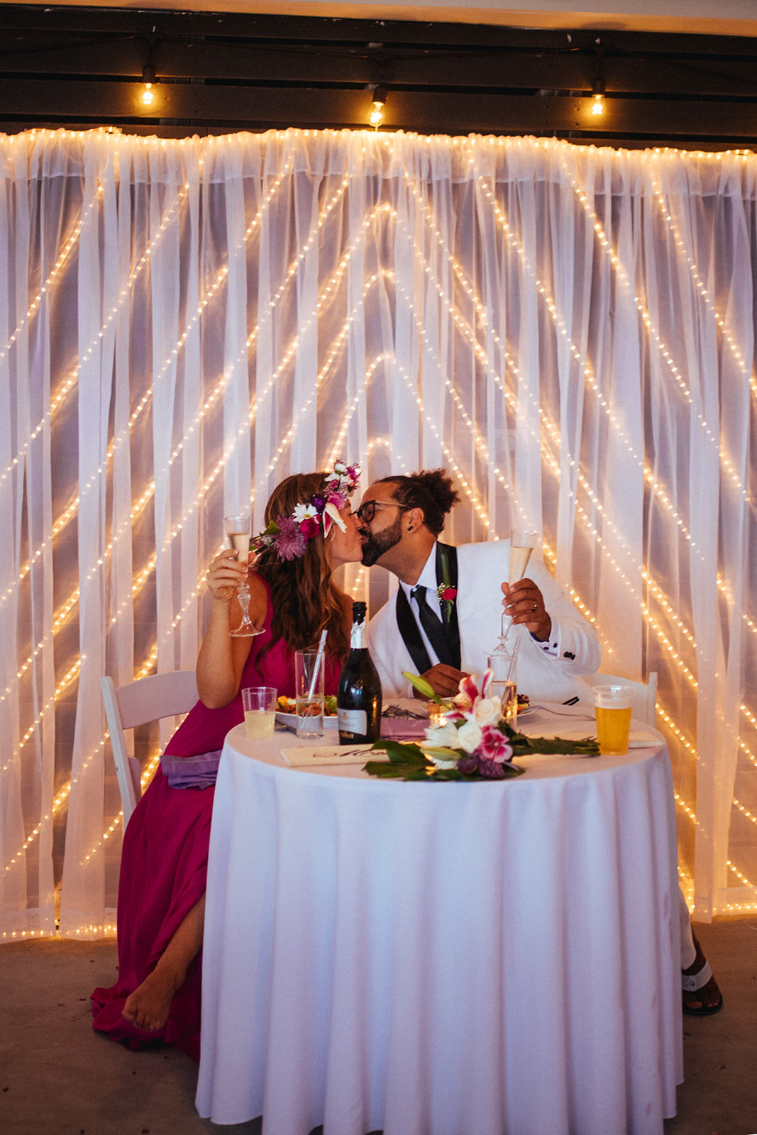 Newlyweds kissing at reception on Folly Beach Shawnee Custalow