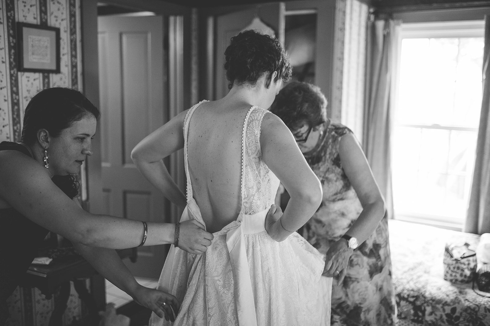 Bride putting on the dress at Black Walnut Point Inn MD Shawnee Custalow photography