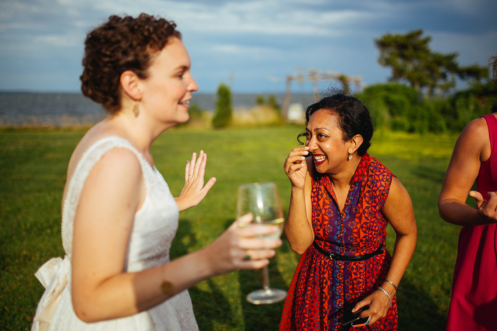Bride laughing with a guest on Tilghman Island MD Shawnee Custalow wedding photography