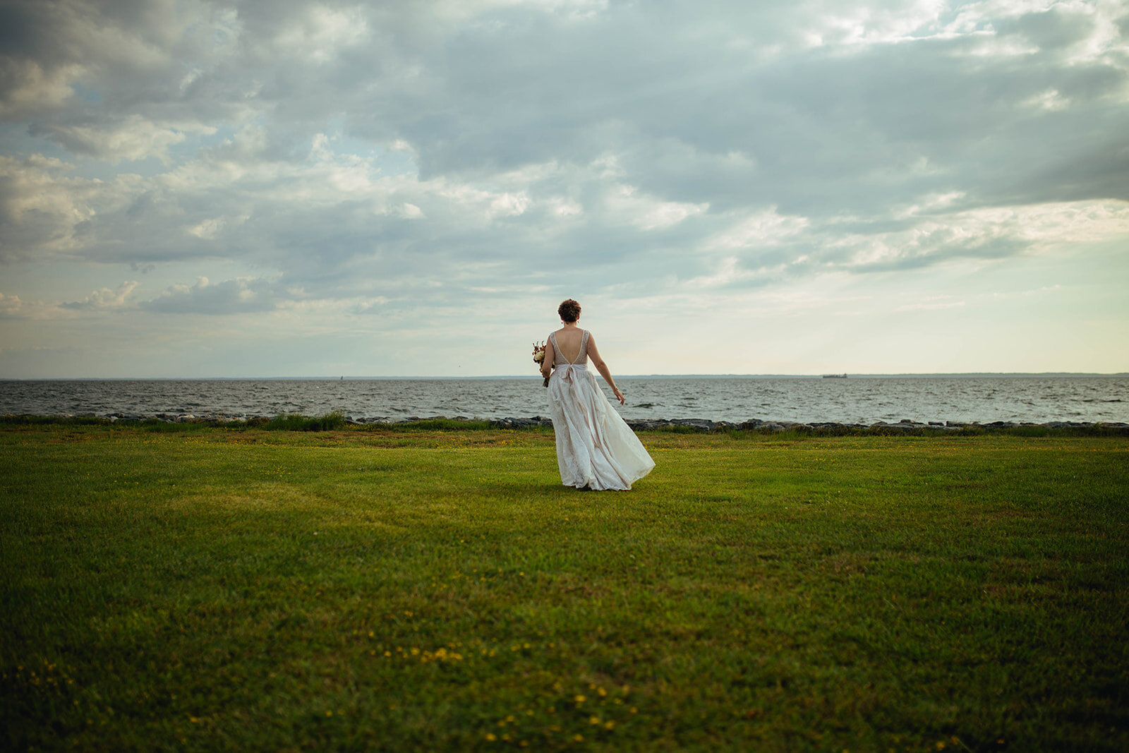Newlywed bride walking to the sea on Tilghman Island MD Shawnee Custalow photography