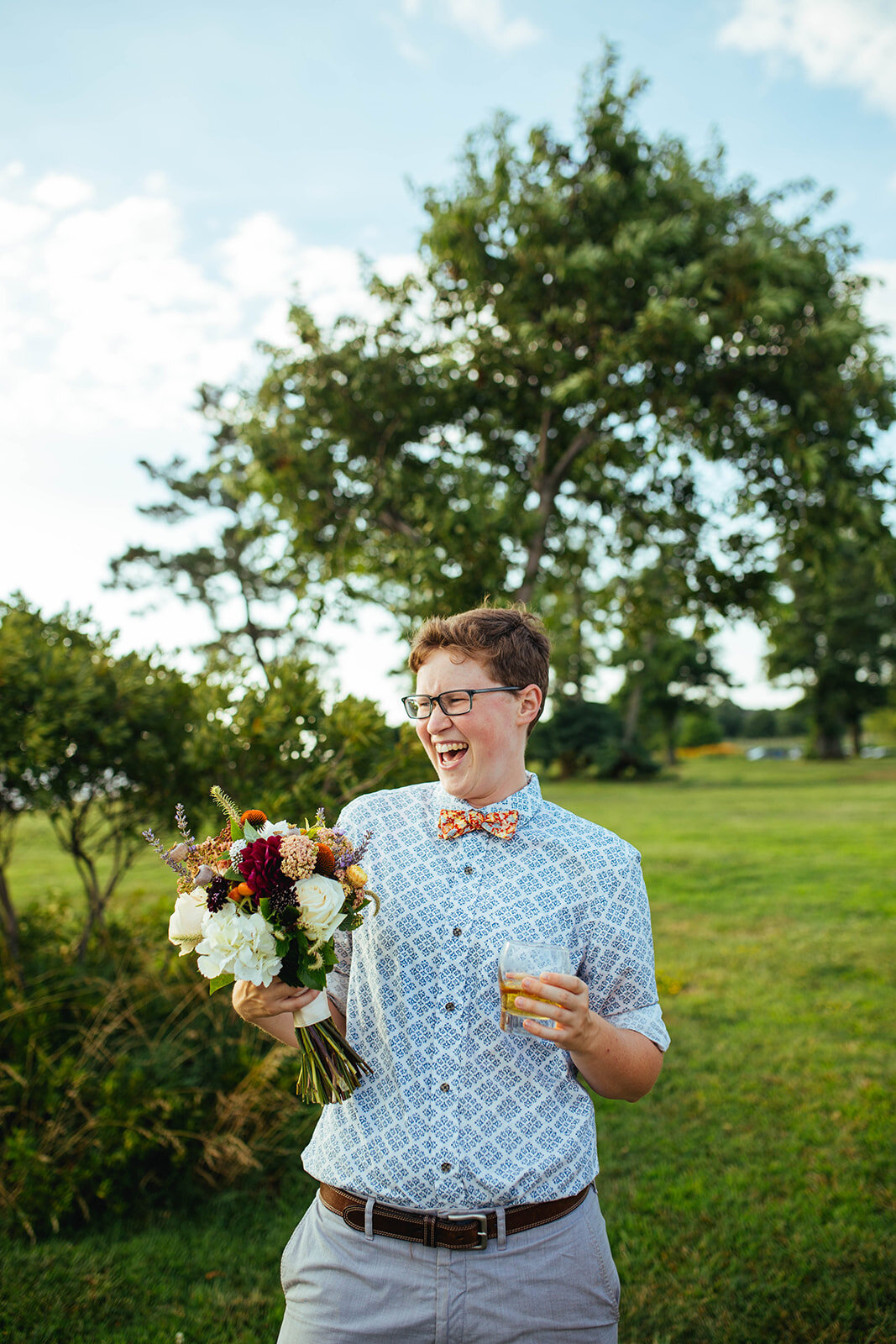 Happy officiant with a bouquet on Tilghman Island MD Shawnee Custalow photography