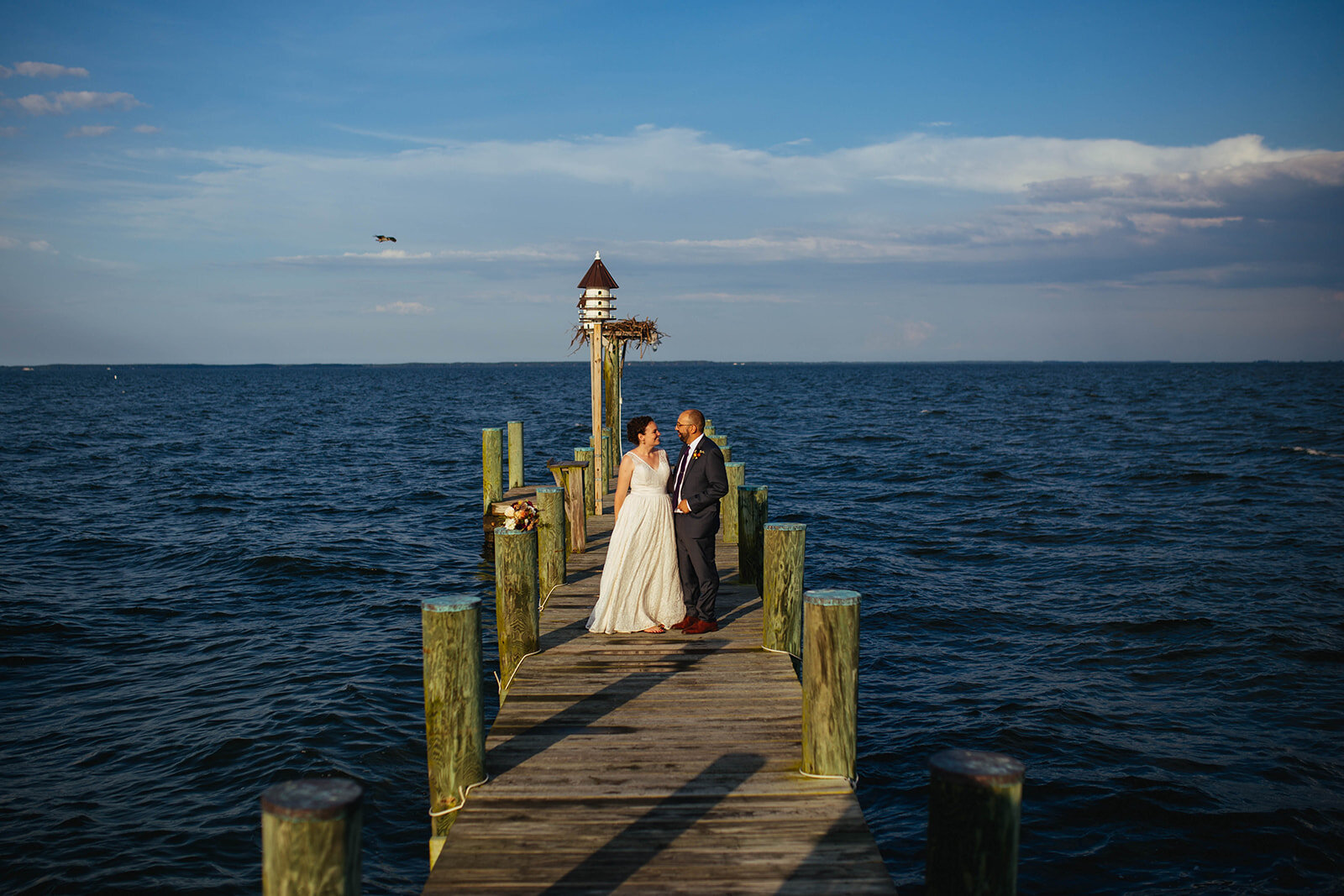 Newlyweds on a pier off Tilghman Island MD Shawnee Custalow wedding photography