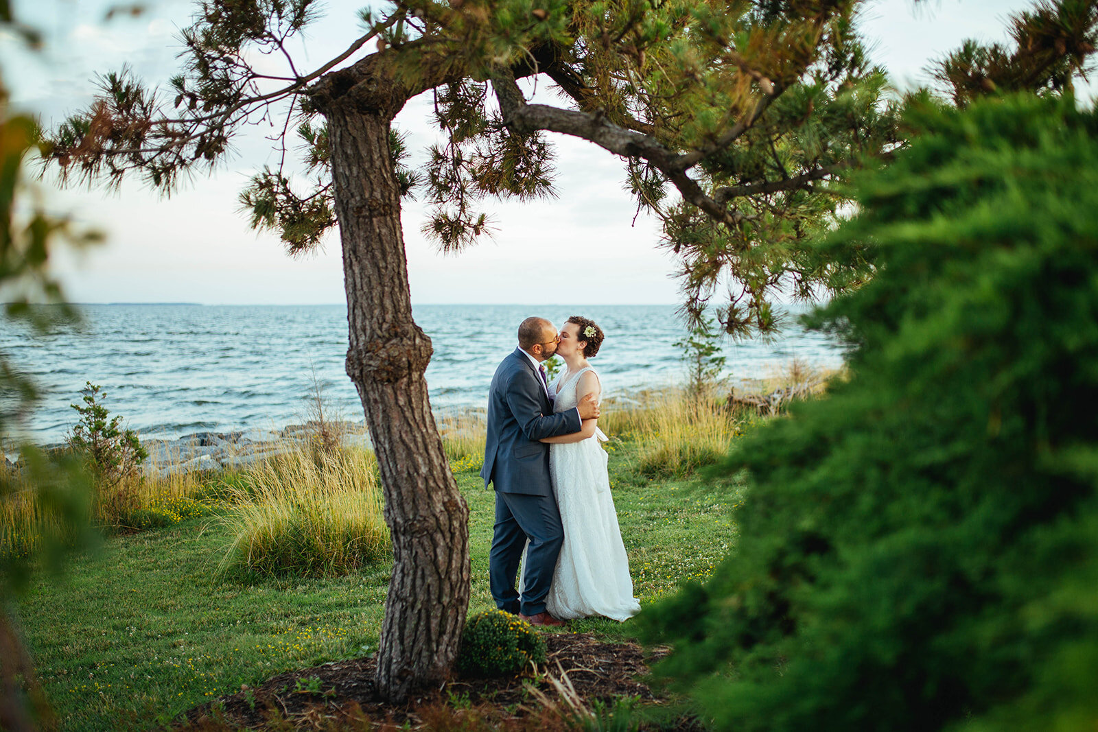 Newlyweds kissing on Tilghman Island MD Shawnee Custalow wedding photography