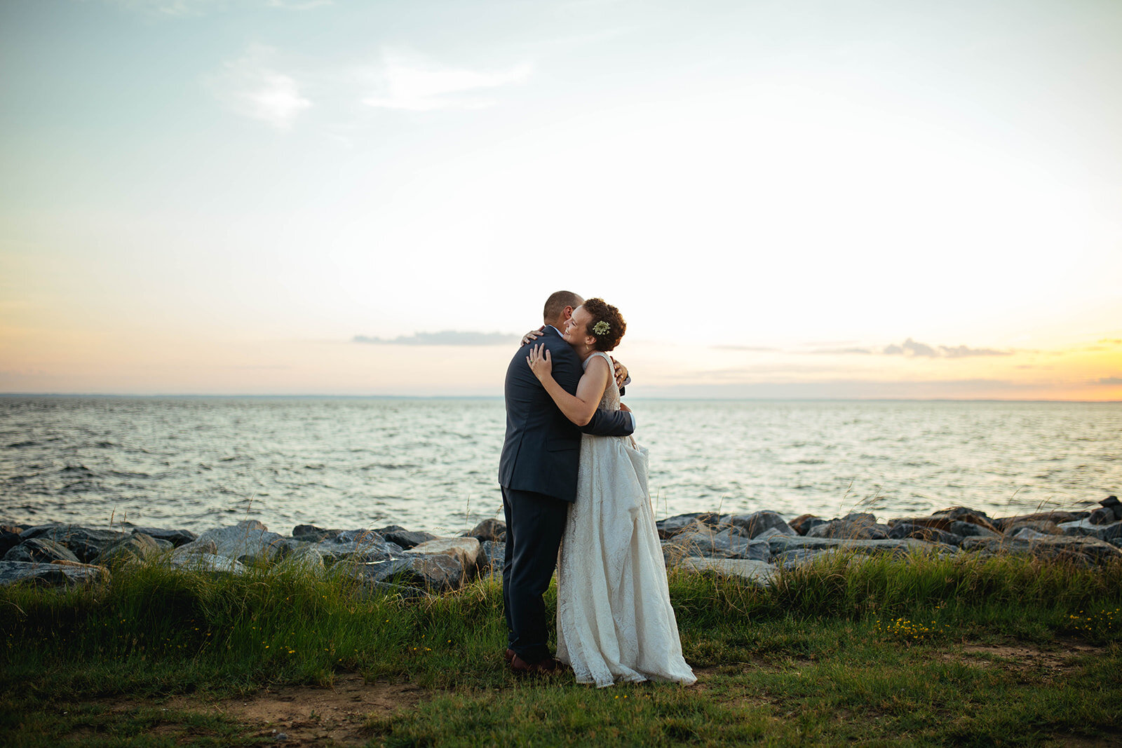 Newlyweds embracing by the sea on Tilghman Island MD Shawnee Custalow photography