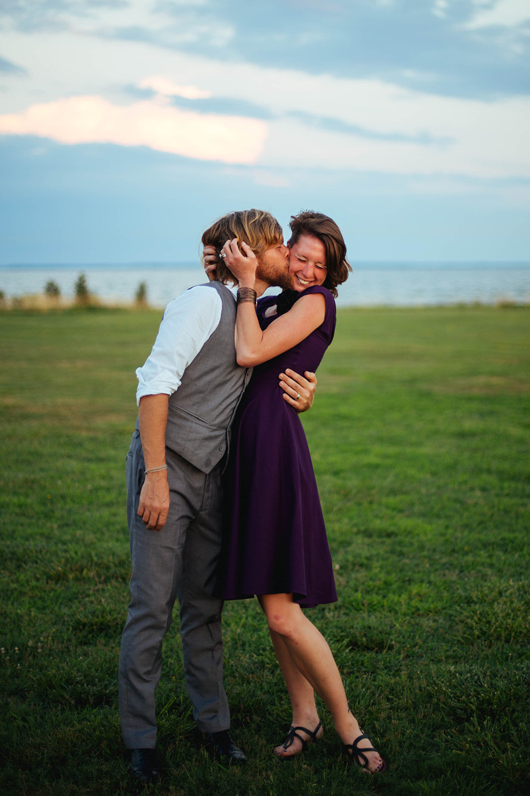 Wedding guests kiss on Tilghman Island MD Shawnee Custalow photography