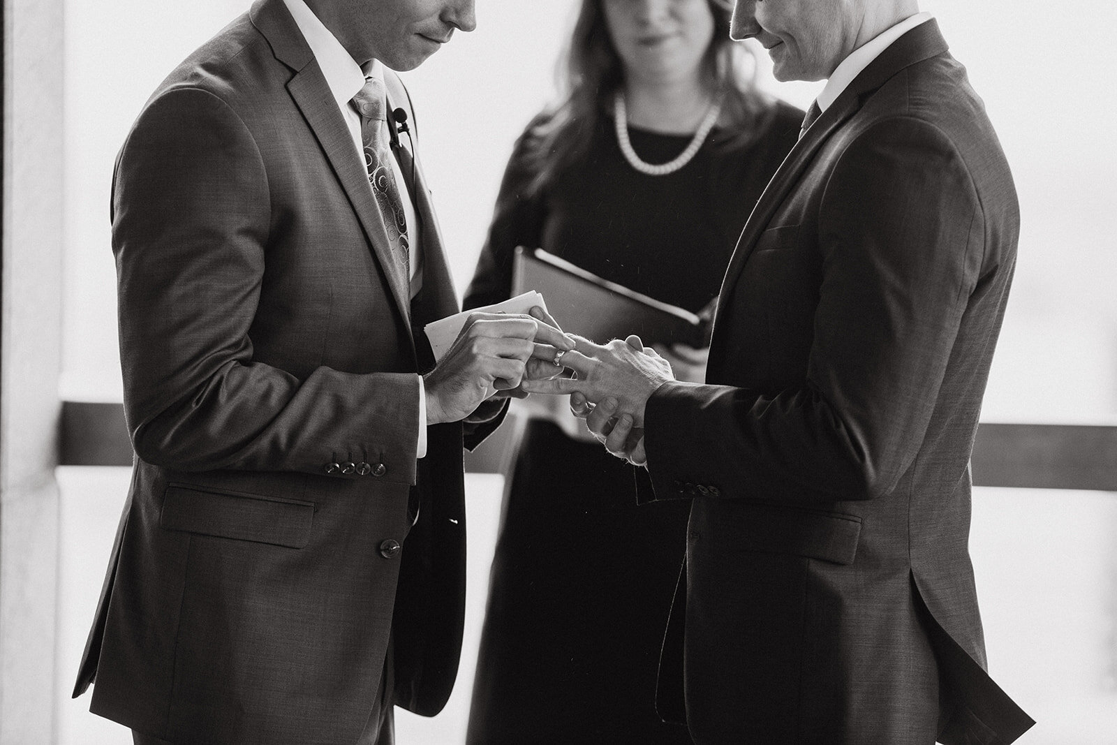 Queer grooms exchanging rings at RVA City Hall Shawnee Custalow wedding photography