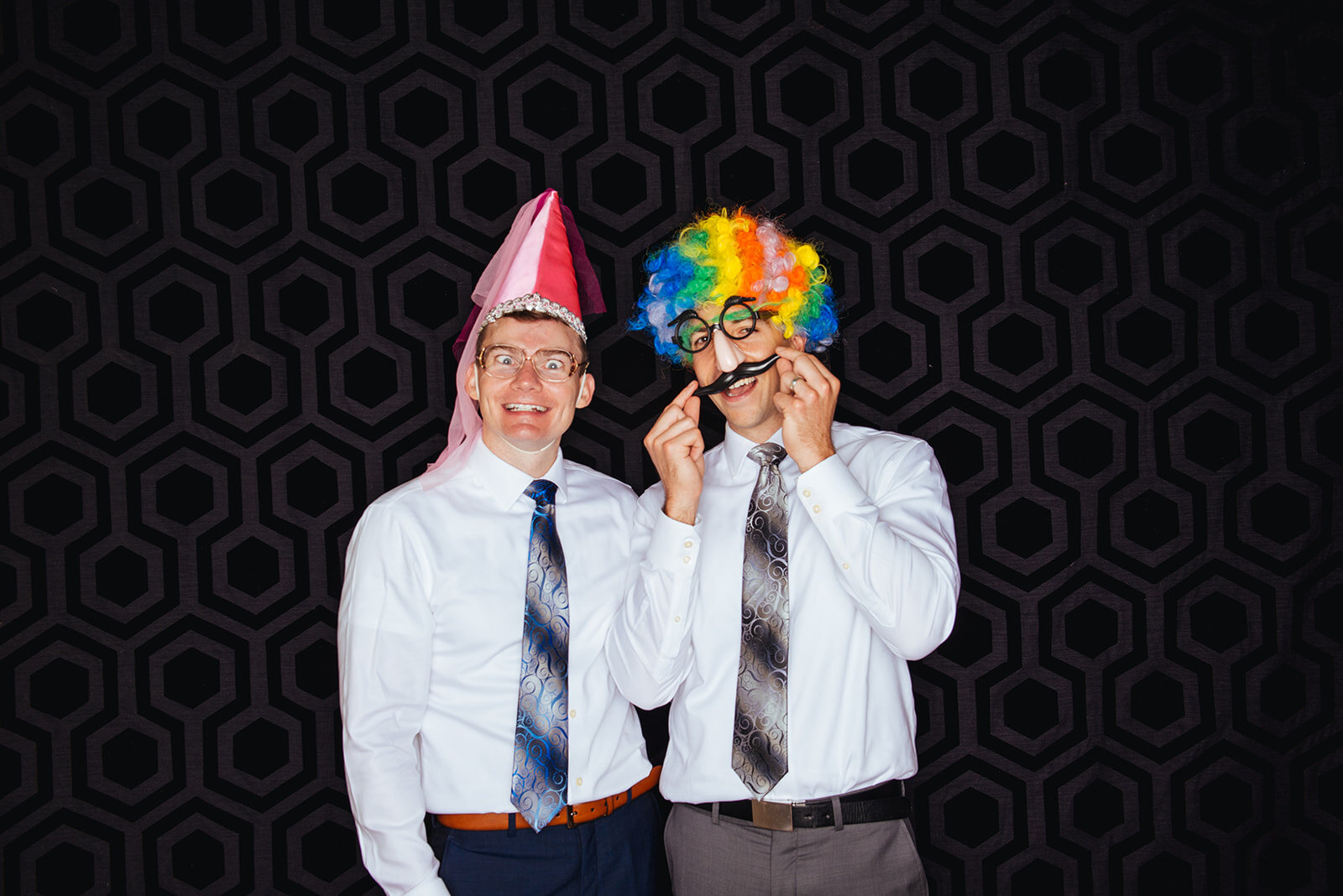 Newlyweds with props in a photobooth at Robinson Theater RVA Shawnee Custalow photography