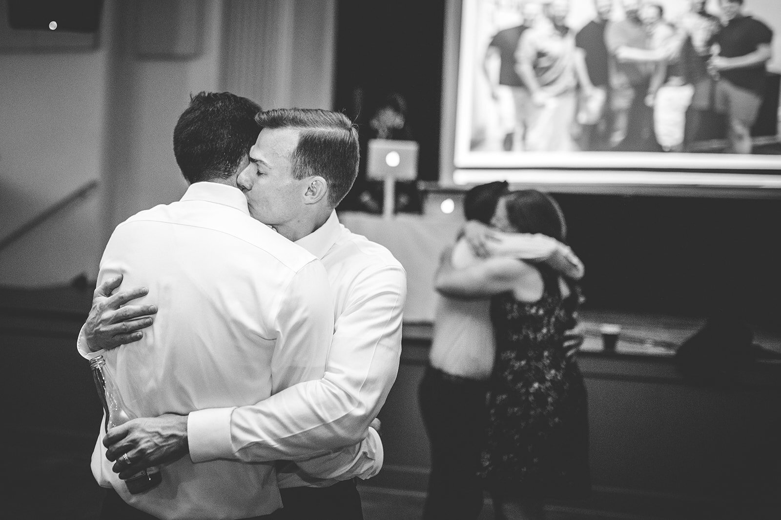 Queer Newlyweds embracing at Robinson Theater RVA Shawnee Custalow wedding photography