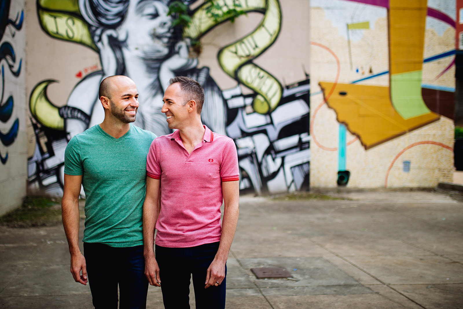 Queer Couple by a colorful mural in Richmond VA Shawnee Custalow photography