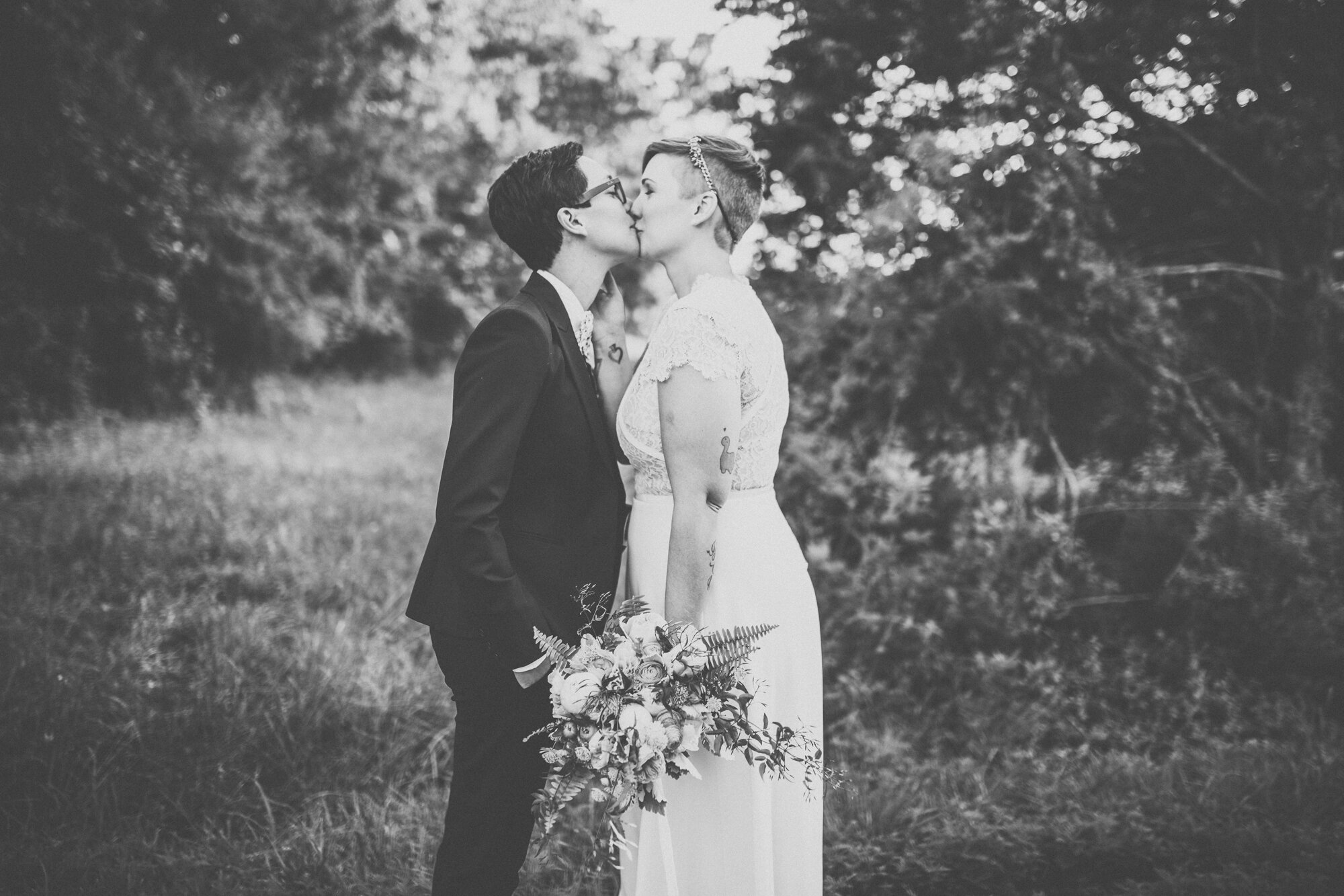 LGBTQ newlyweds lean in to kiss in Richmond VA Shawnee Custalow wedding photography