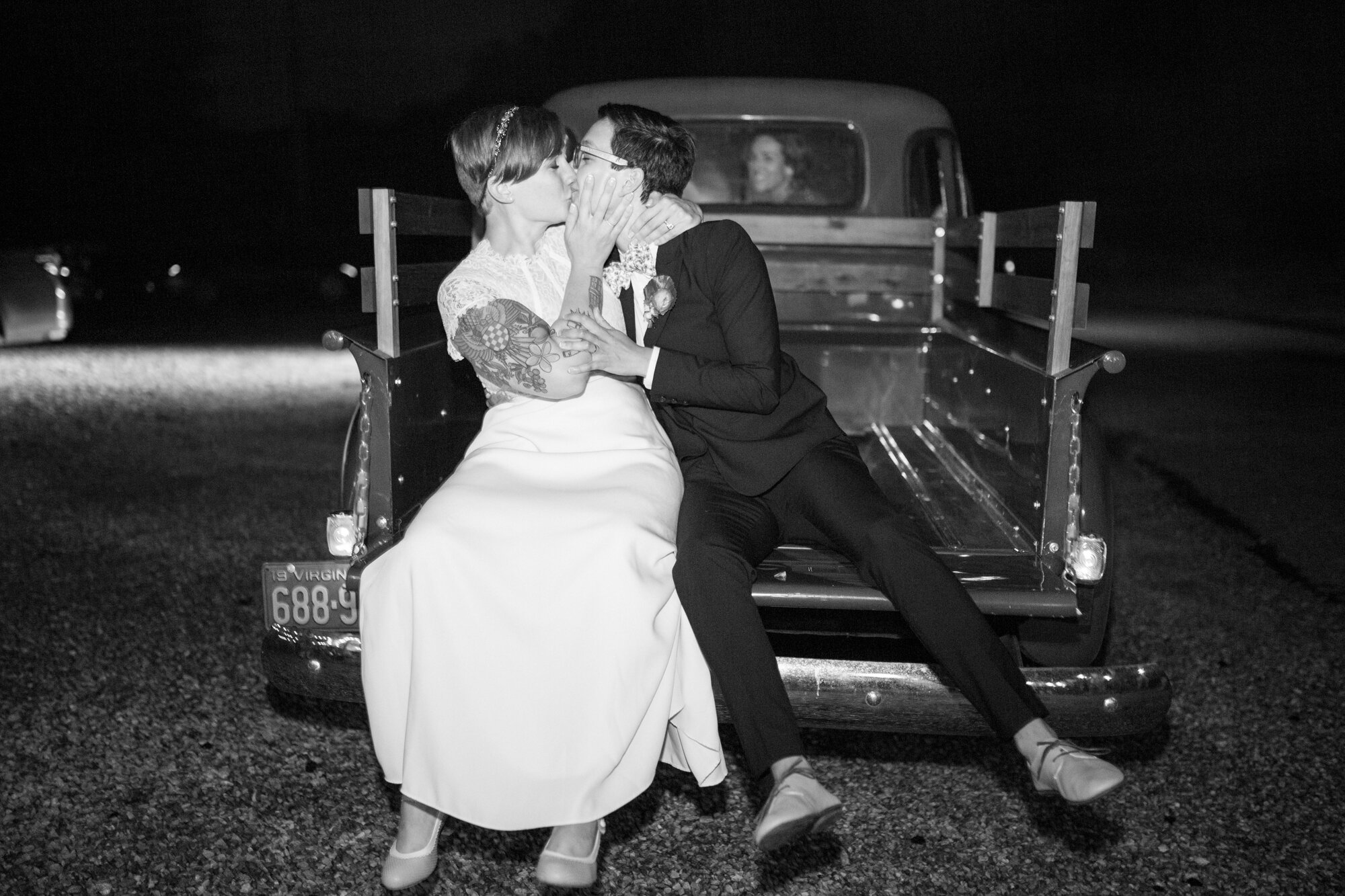 Newlyweds kissing on the back of a truck in Richmond VA Shawnee Custalow photography