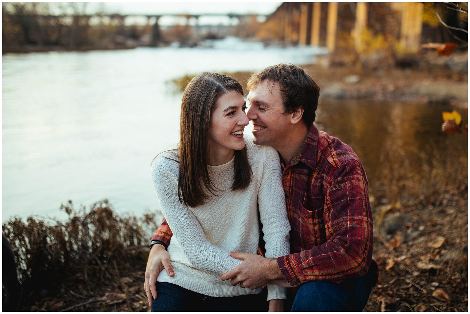 Happy couple sitting by the James River Richmond VA Shawnee Custalow photography