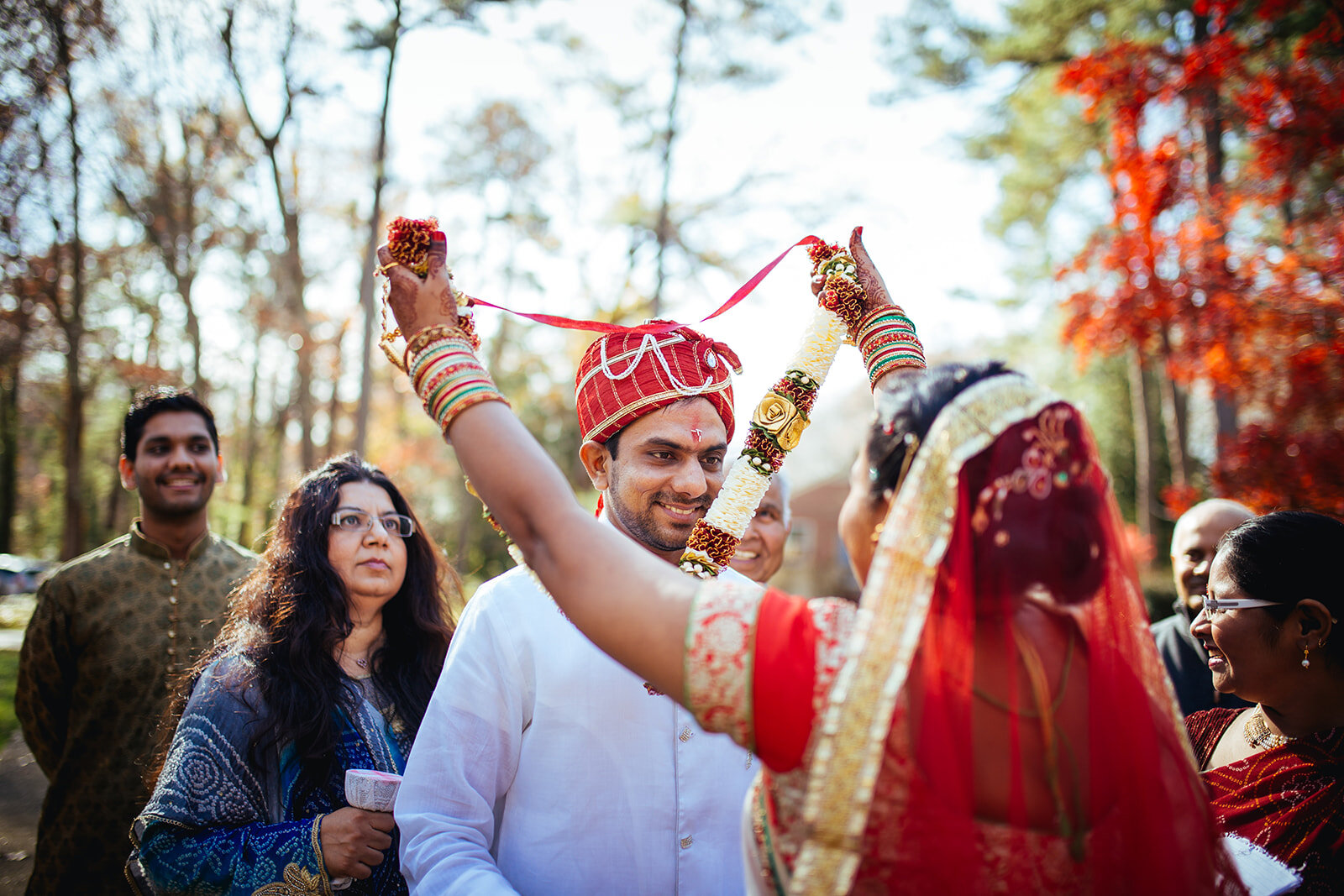 Indian Bride putting a garland on the Groom in RVA Shawnee Custalow wedding photography